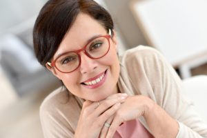 'woman smiling after receiving bone graft'