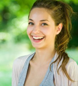 'woman smiling after wisdom tooth extraction'