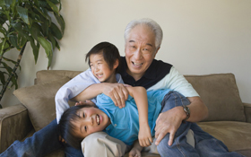 Smiling grandfather who was a recipient of the dental implant procedure provided by Cupertino oral surgeon Dr. Nima Massoomi.