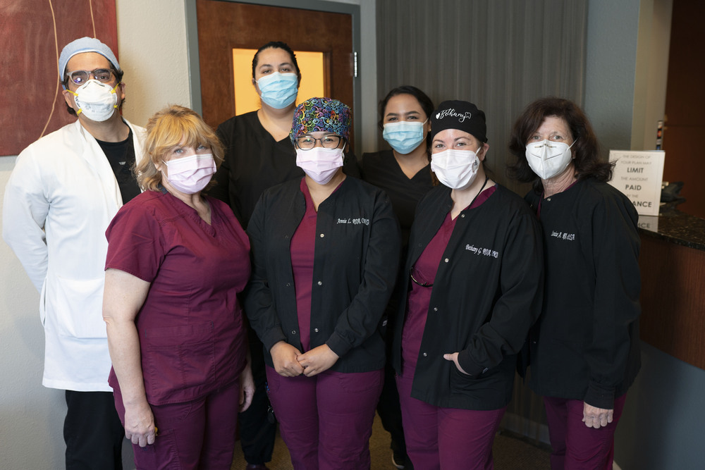 Cupertino oral surgeon Dr. Massoomi waiting with staff inside one of the negative pressure operating rooms at his practice.